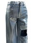 Silver metallic coated denim pants with left front printing and damage points. Made from Cotton 30% /Polyester 70%.
