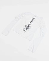 back view of white longsleeve top with ruched sleeves and back print