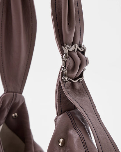 mauve leather shoulder bag with bespoke buckle