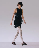 Side view of black top with ruching detail on body