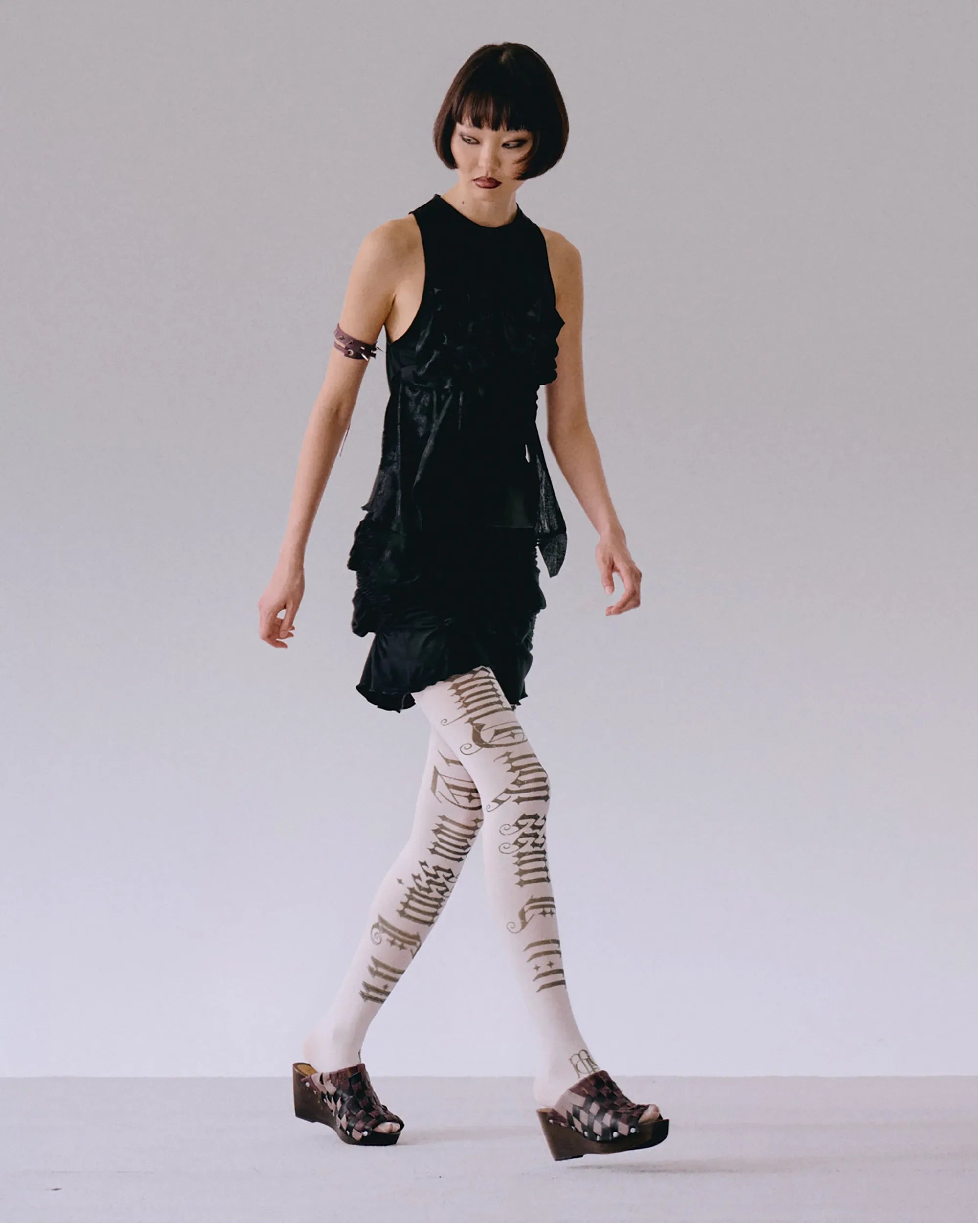 Side view of black top with ruching detail on body